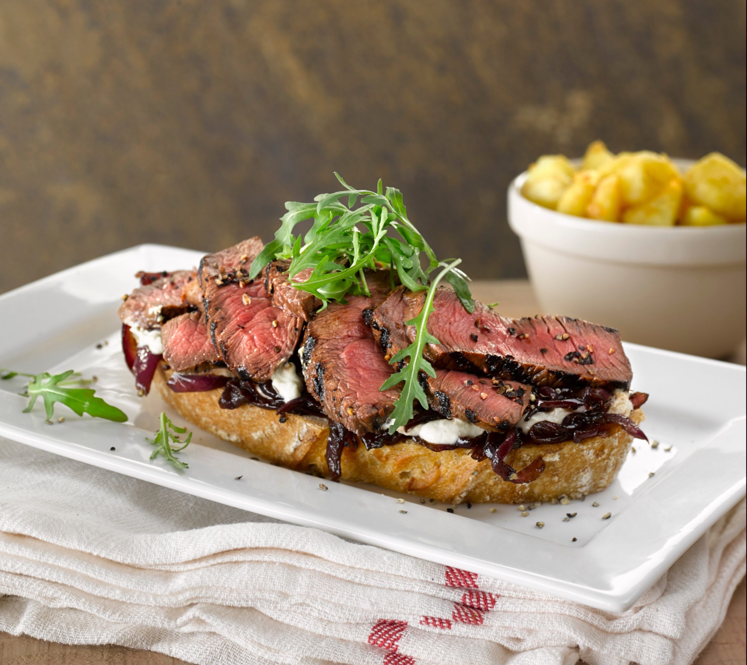 Sliced steak with caramelised red onions